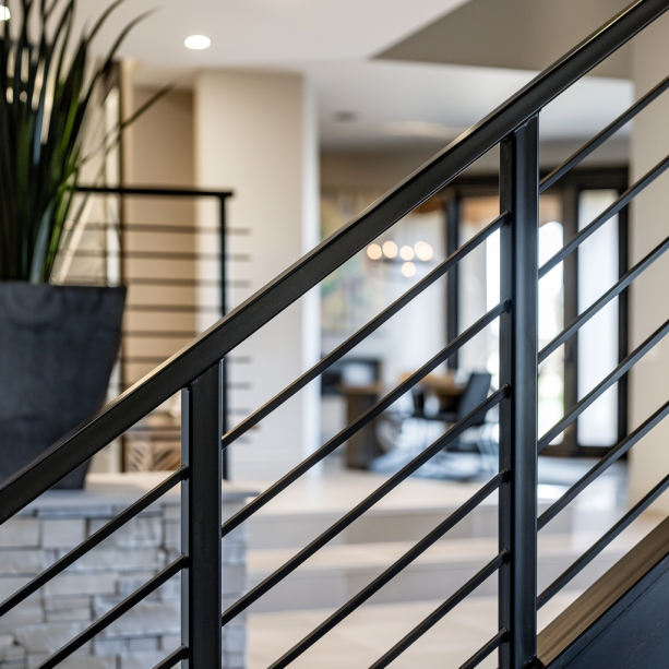 minimalist black metal railings, modern interior, staircase, pale walls, simple style.