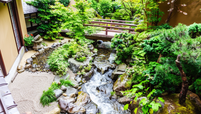 Japanese balcony garden, winding stream, flowing water, river pebbles, footbridges.