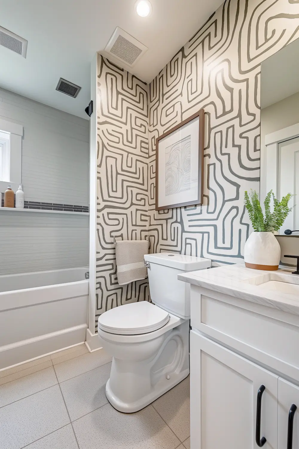 Contemporary bathroom with patterned walls white cabinetry and modern fixtures and greenery