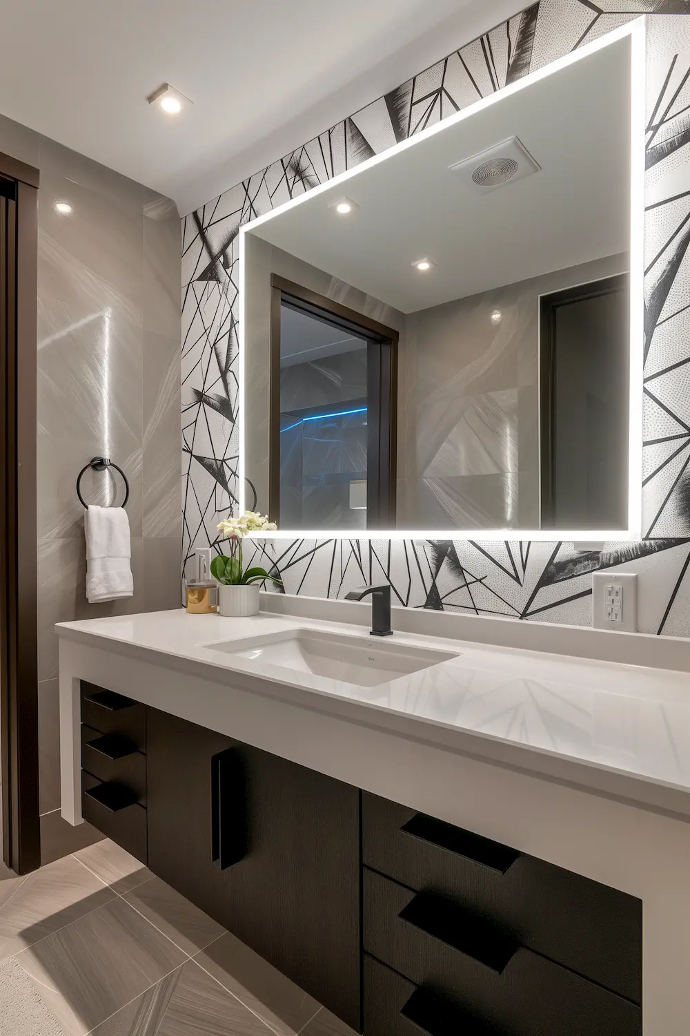 Sleek bathroom with modern black and white design illuminated mirror and contemporary fixtures