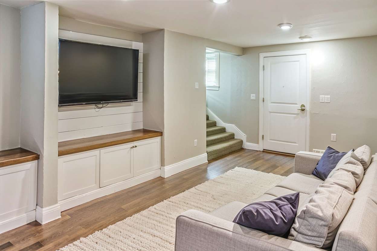 small minimalist basement with tv and neutral colors