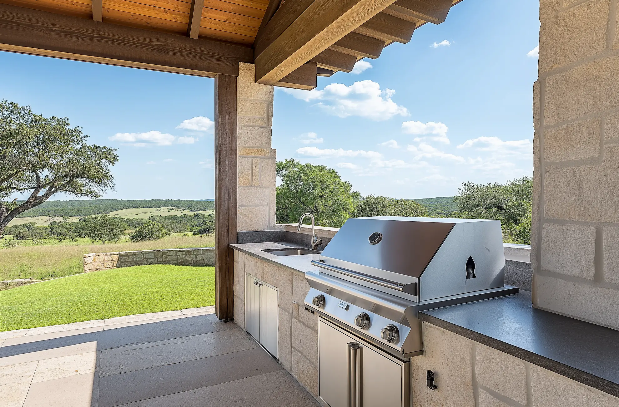 Modern outdoor kitchen with a grill and scenic landscape view