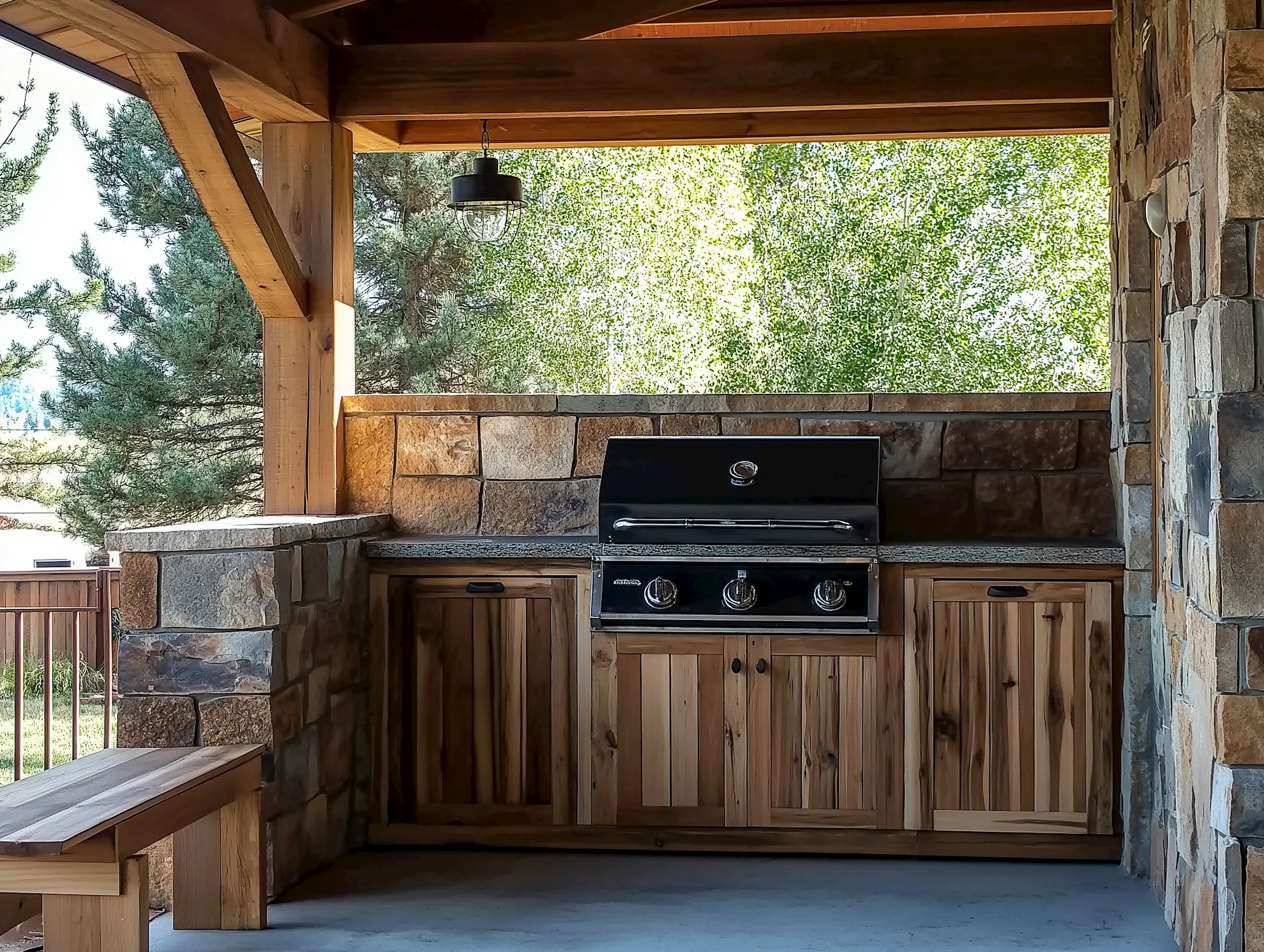 Outdoor kitchen featuring a gas grill and wooden cabinets under a sheltered patio