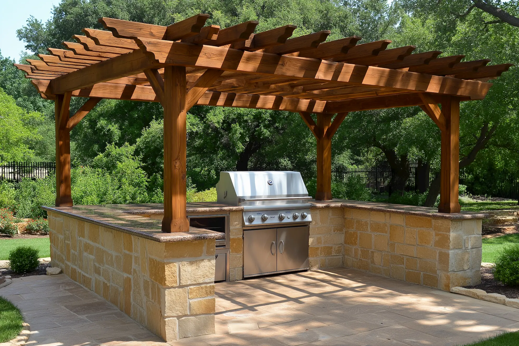 Outdoor kitchen with a wooden pergola and stainless steel grill in a lush garden